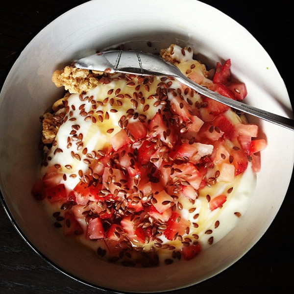 Snack Time: Chia orange granola, chopped brazil nuts,a dollop of almond cultured yoghurt and chopped strawberries with flax seeds